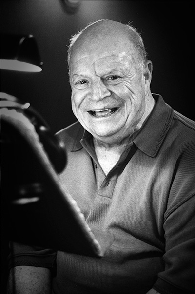 a portrait of Don Rickles in a recording studio