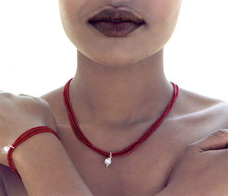 fashion photograph of an african-american woman with a red necklace and bracelet